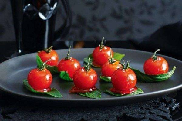 Candied tomatoes on basil leaves